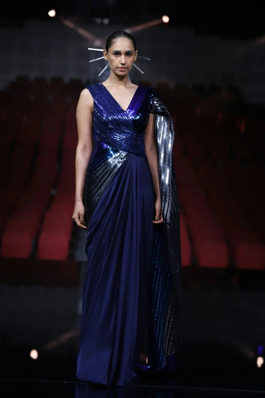 the model in a dress with metallic straps
