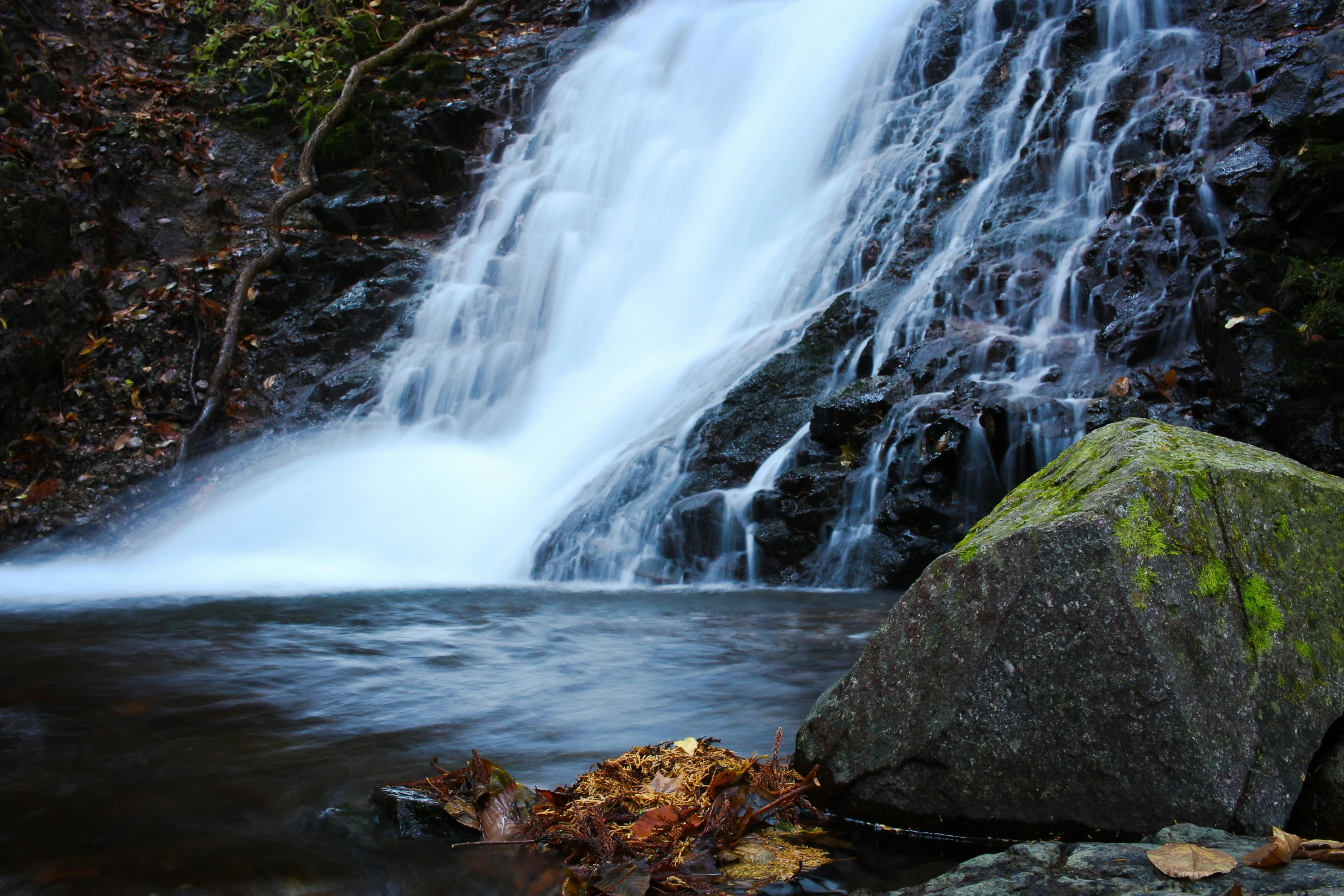 a waterfall that is next to a river