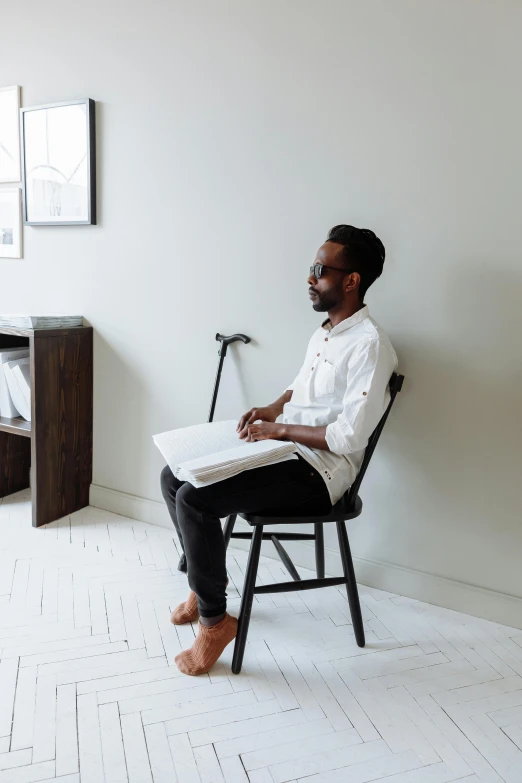 a man sitting on a chair in front of a desk