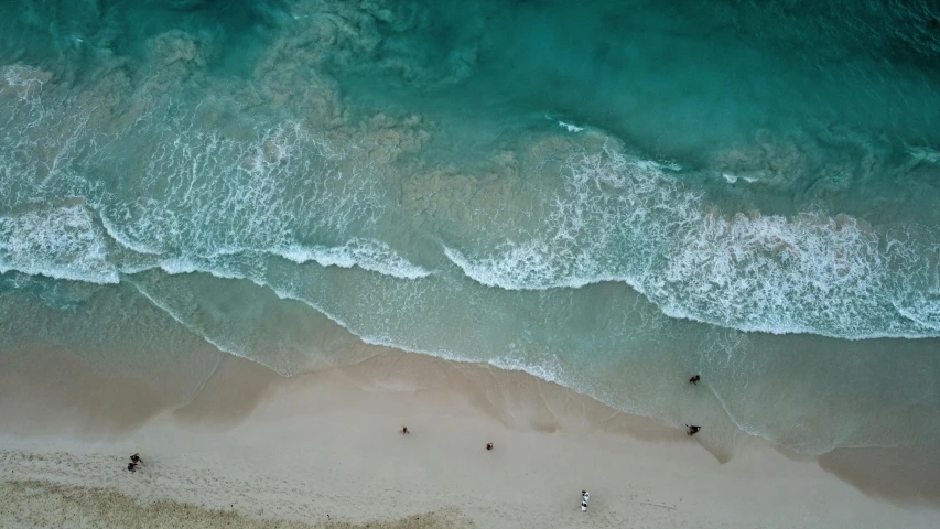 a group of people on the beach with surf