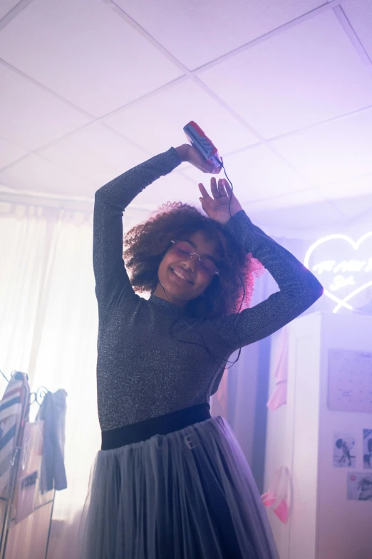 a woman in a skirt is holding up her hair and wearing a brush