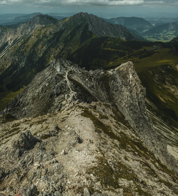 a high angle view of some mountains covered in grass and rocks