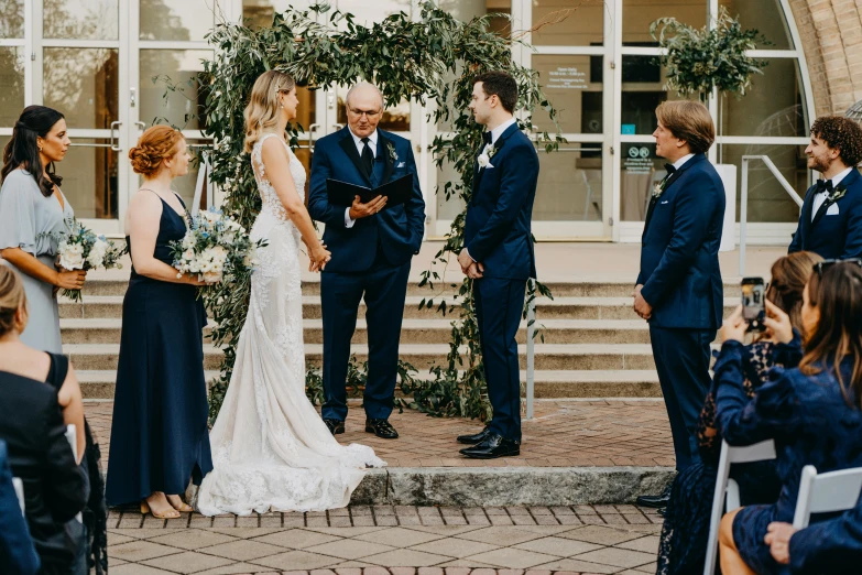 a couple is getting married while others watch