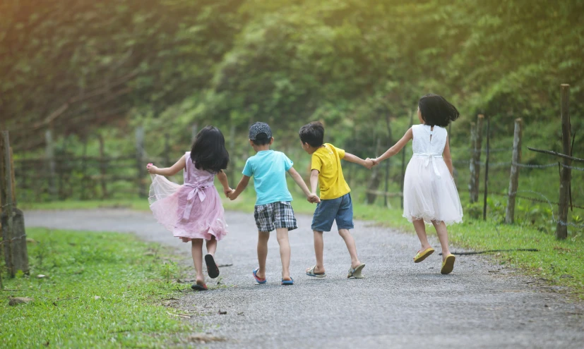 three little s holding hands as they walk together