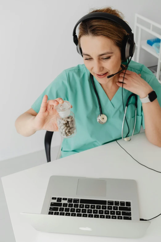 a woman sits at a table with a keyboard and headset