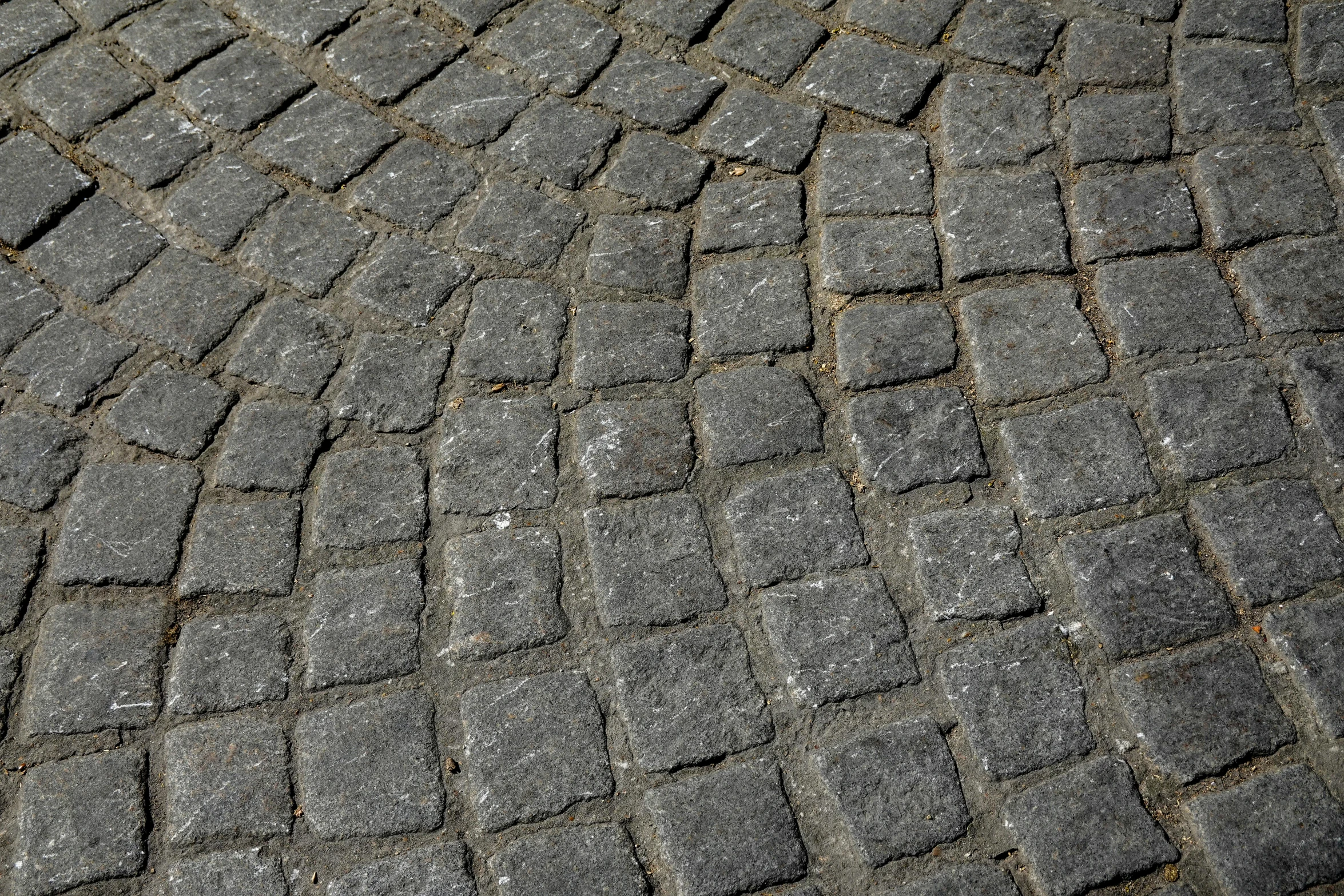 the background image of small squares of cobblestone pavement