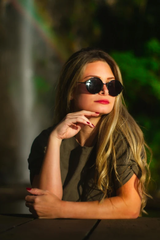 the woman is wearing sunglasses and posing for a picture