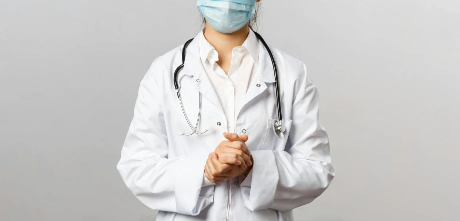 a nurse in white jacket and medical mask