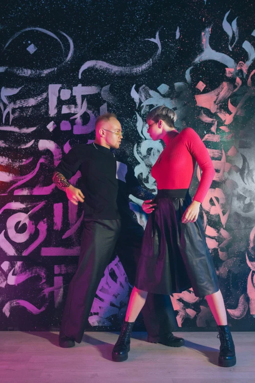 a male and female dancing in an artistic setting