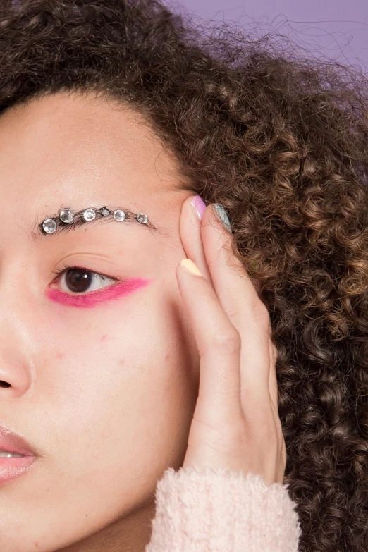 a young woman with some bright pink makeup on her face