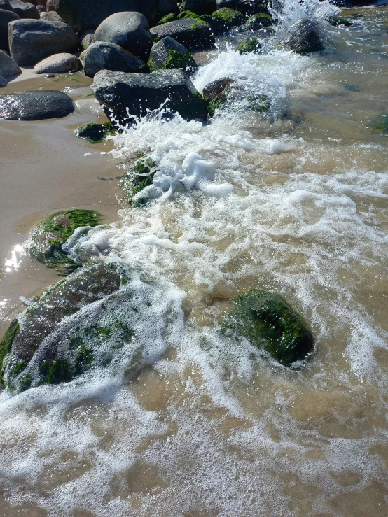 some rocks that have been washed into the water