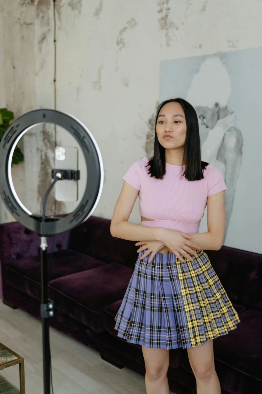 an attractive young woman posing for a po in front of a camera