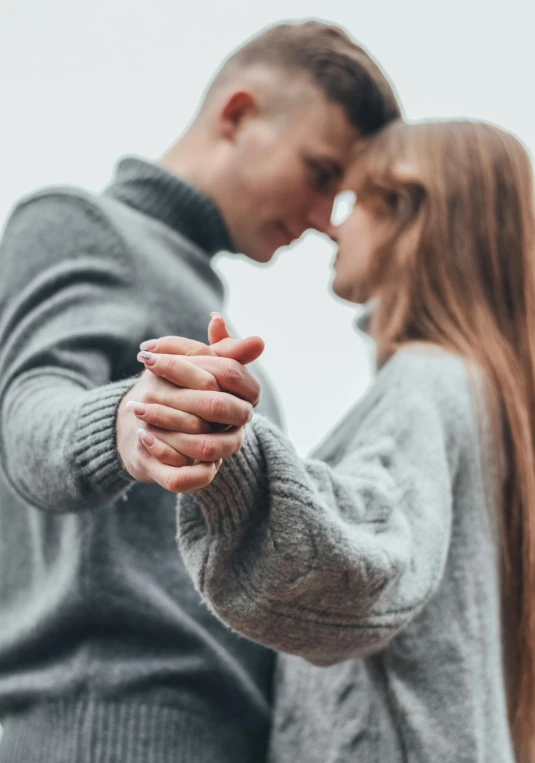 man and woman who are hugging while pointing at each other