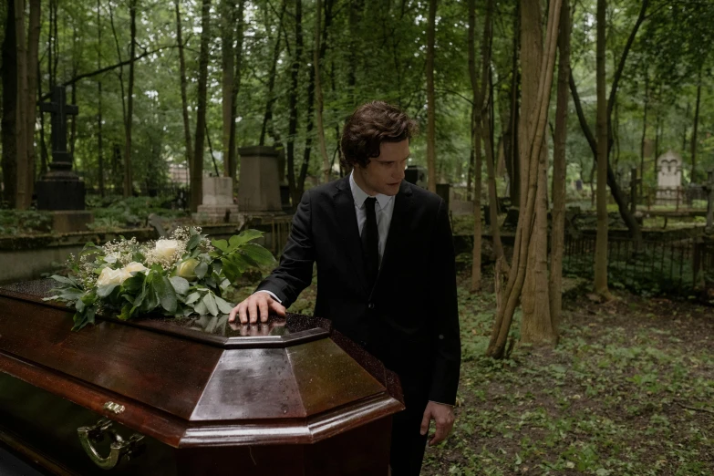 the young man is looking at his casket