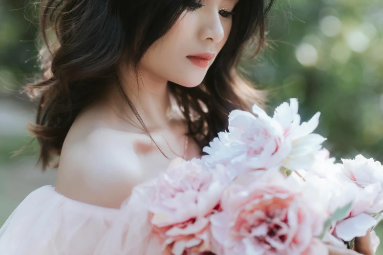 a woman holding a bouquet of flowers in her hands