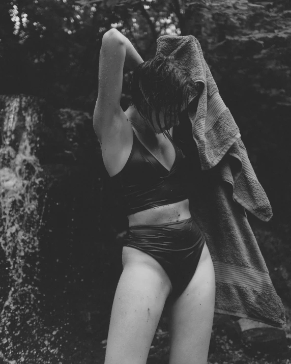 woman in short underwear near waterfall with trees