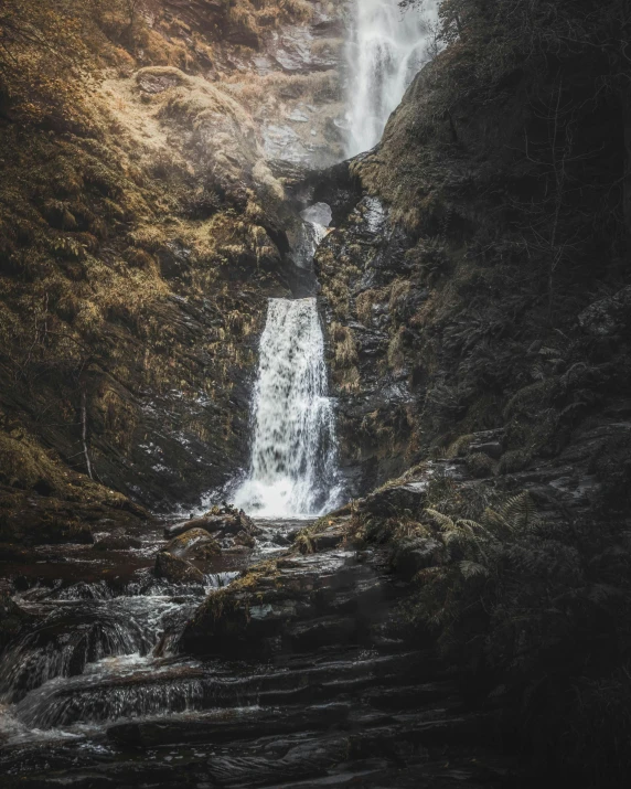 waterfall flowing into a stream on a mountain