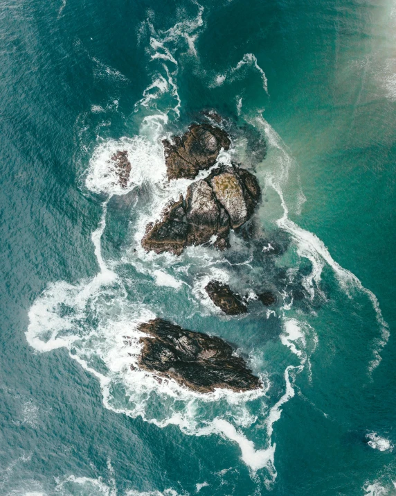 a po taken from above of some rocks by the water