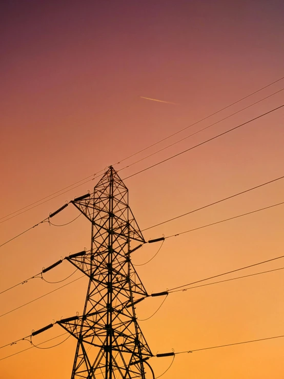 a power tower stands at the top of a field