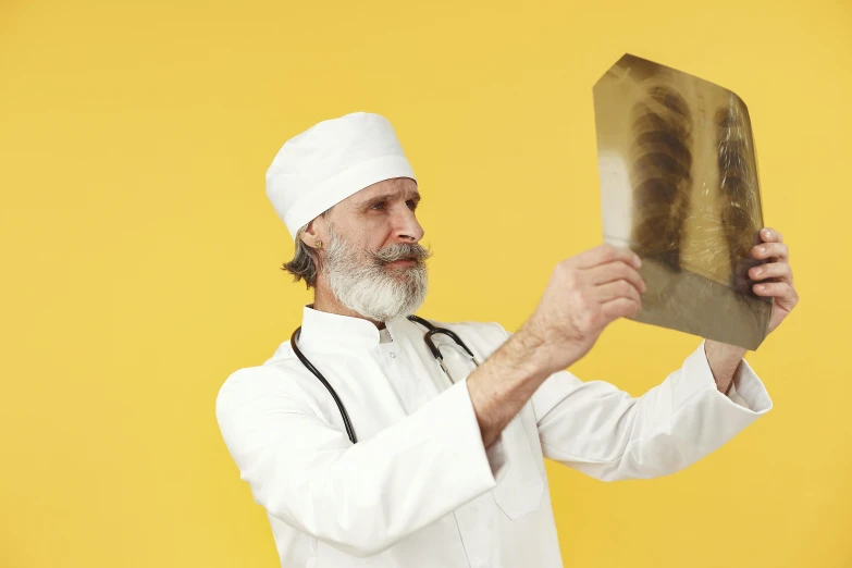 the man in a white uniform is holding up a knife