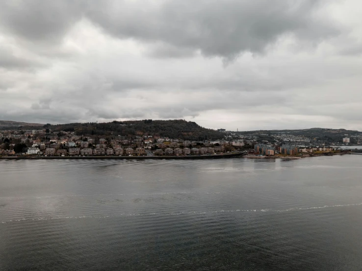 the water has small waves as it is surrounded by a city