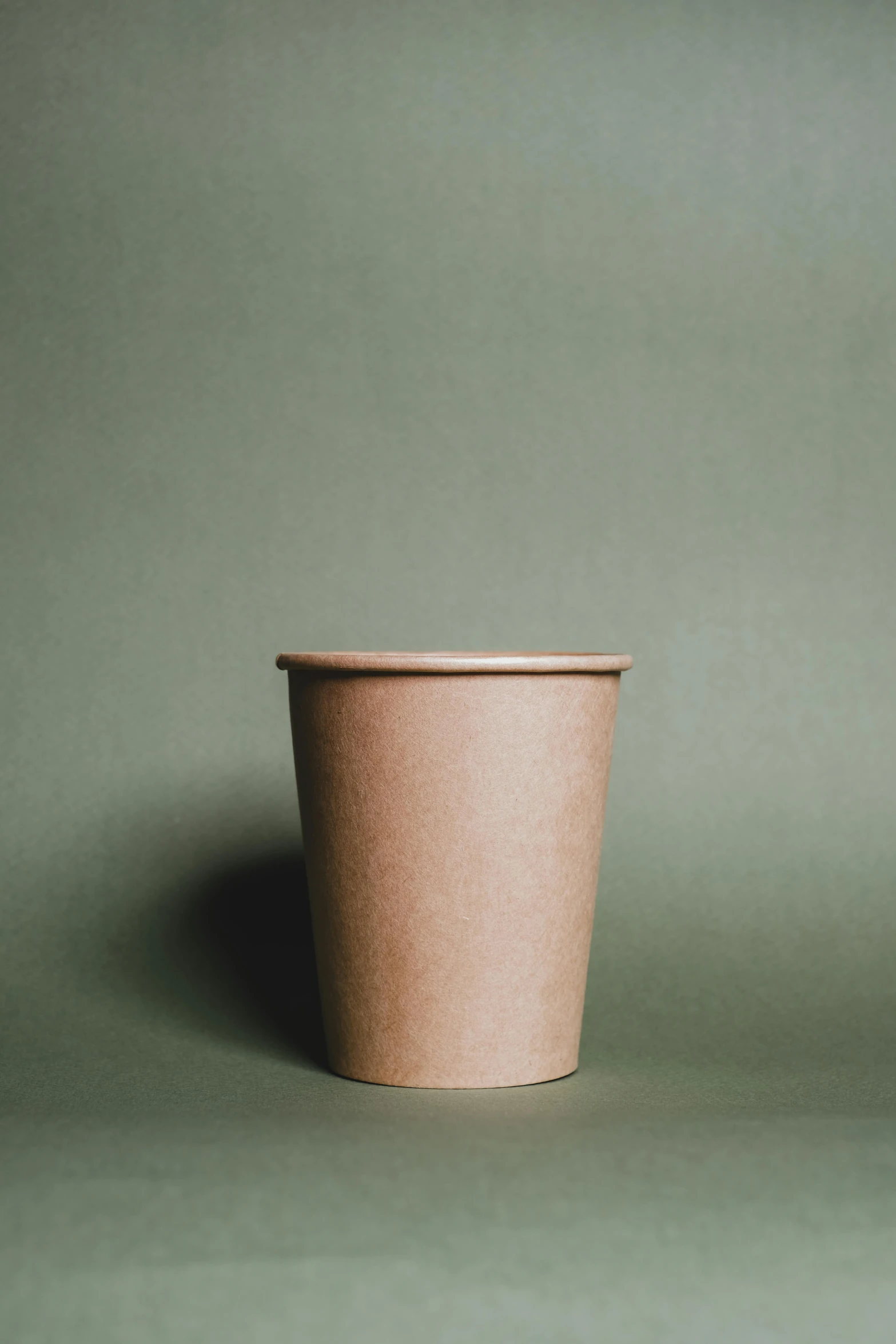the large paper cup is shown on a grey background