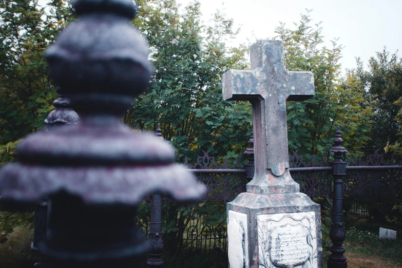 a small cross that is on a fence