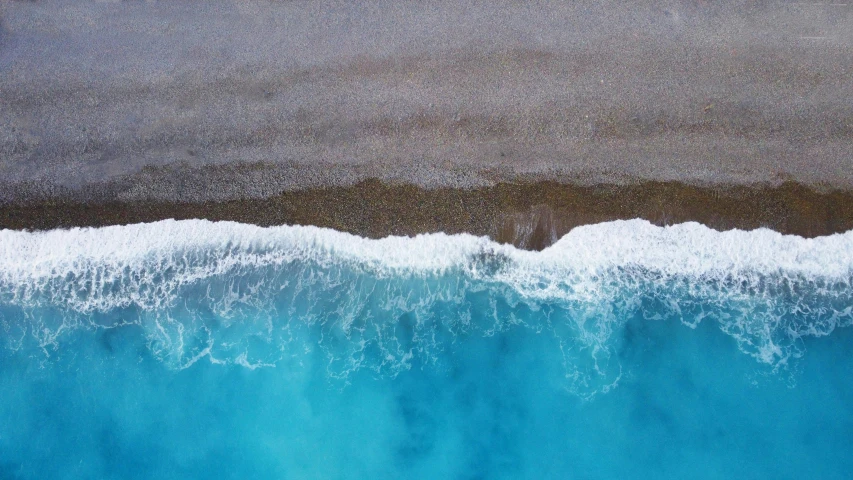 blue water with waves in it and some rocks