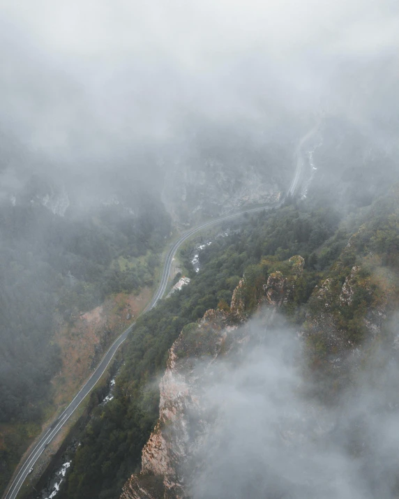 a long winding road on the side of a mountain side