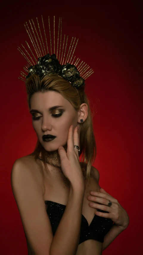 an image of a woman with gold spikes on her head