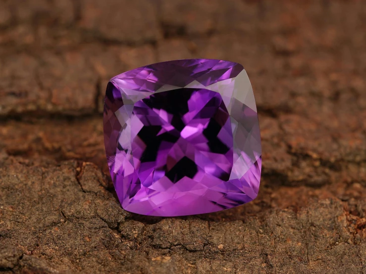 purple, rectangular shape gems sitting on a wood surface