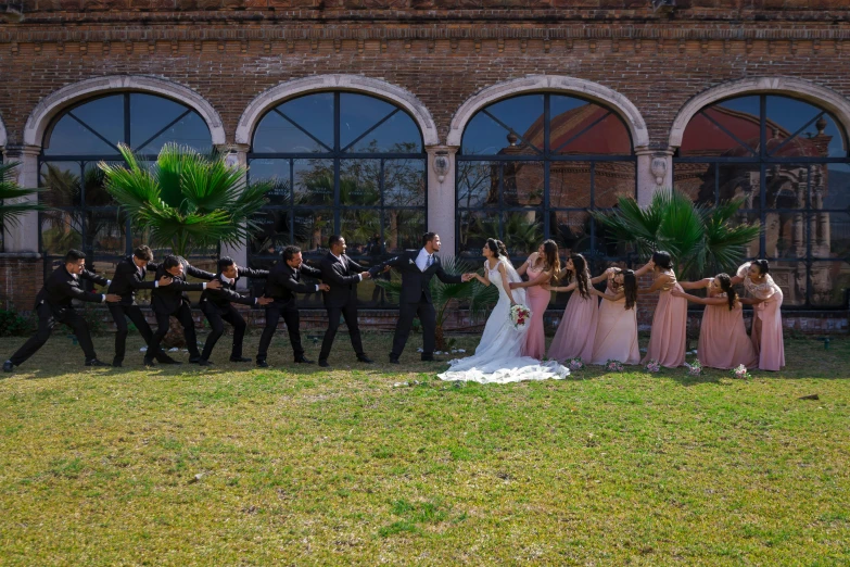 an image of wedding party posing by the window