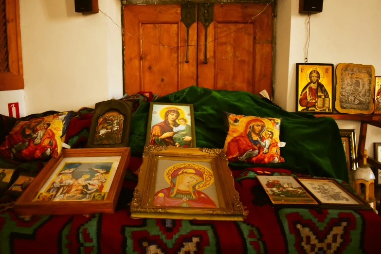 the catholic art is displayed on the red blanket