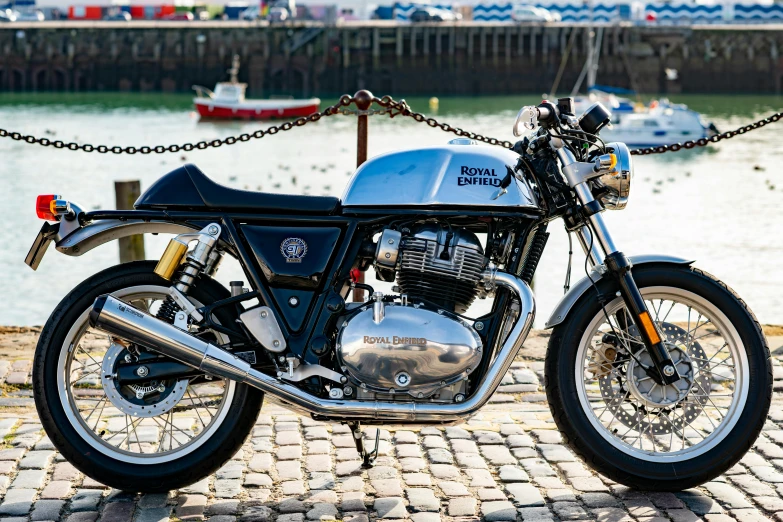 the motorcycle is parked next to a pier