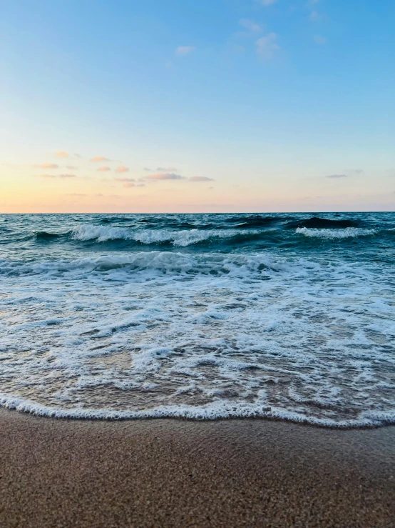 a view of a blue ocean water and a sandy beach