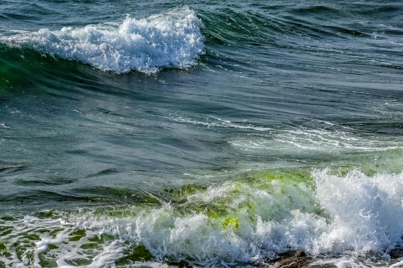 some water waves crashing on the beach