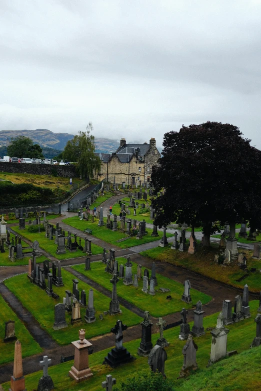 an cemetery on a cloudy day with many tombstones