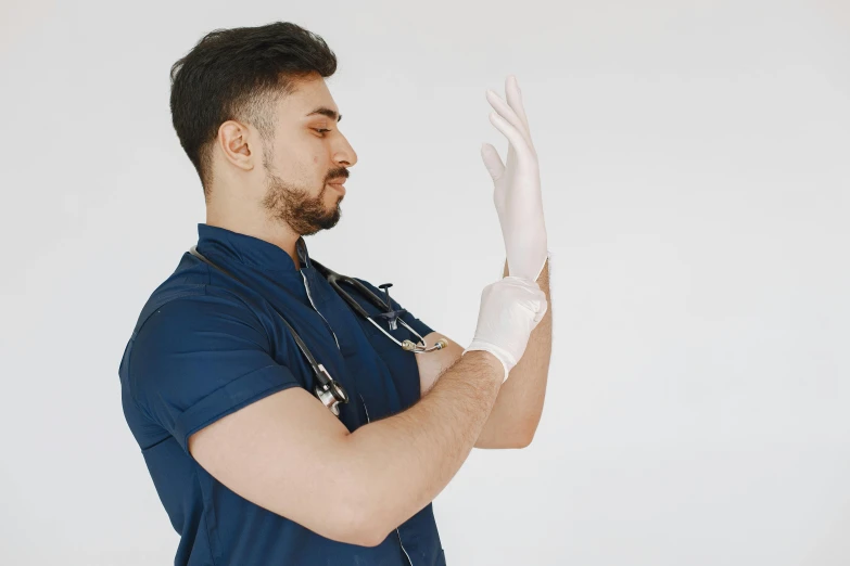 a man in scrub clothes and medical gloves