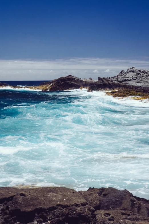 some waves crashing on the rocks by the ocean