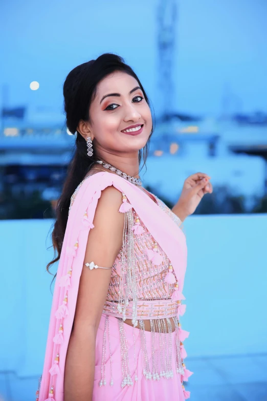 a woman in a pink sari posing