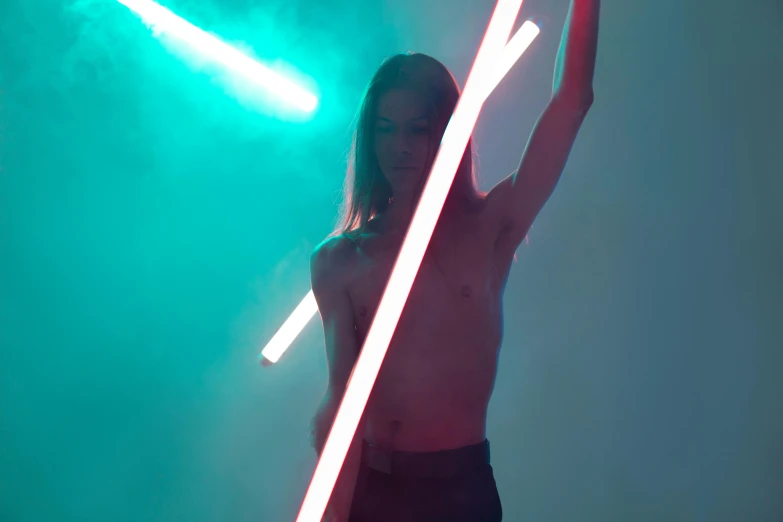a woman standing under a green light holding two large white lights