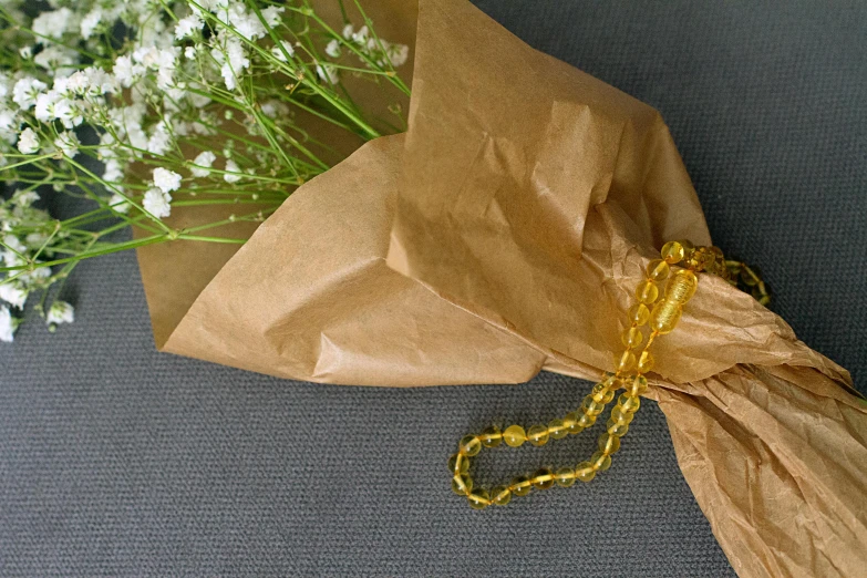 a bunch of flowers is wrapped in a paper bag