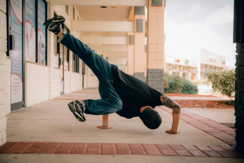 a man is in the air doing a handstand while holding his skateboard