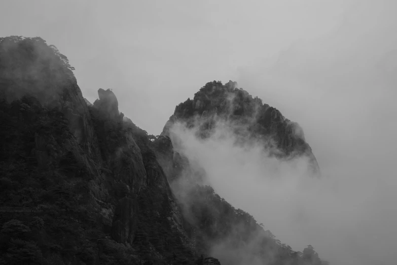 the mountain covered with clouds and mist during a cloudy day