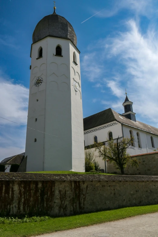 a tall white church tower with a steeple