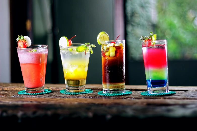 various colored drinks sitting on top of a table