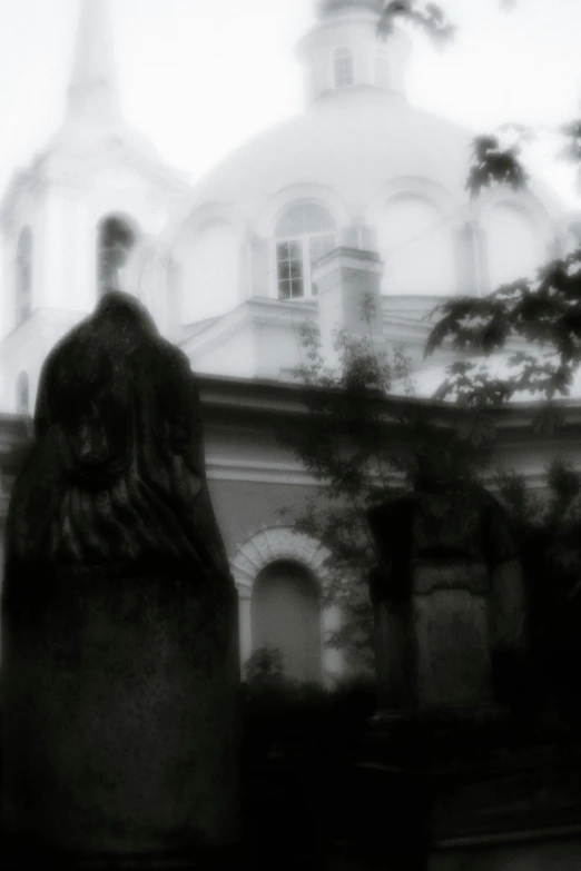 a church with steeples and a statue outside