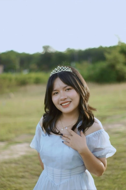 a  wearing a tiara posing for a po