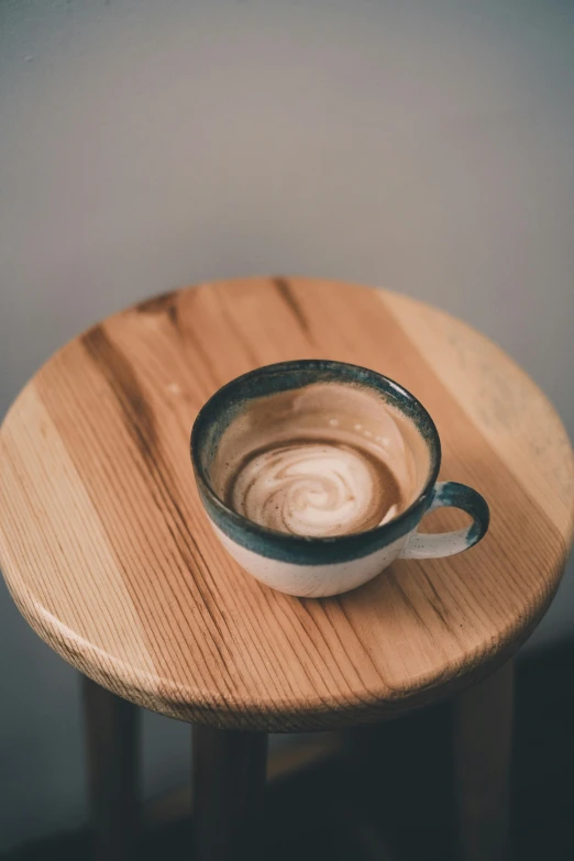 an empty coffee cup on a small wooden table