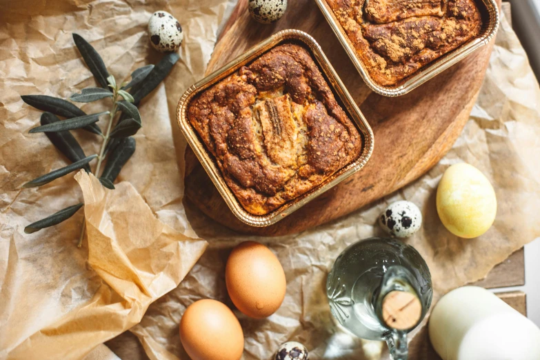 three loafs of cake sit on top of a wooden board